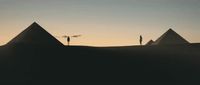 a group of people standing on top of three pyramids