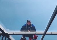 a man standing on top of a metal structure