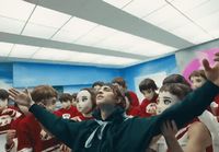 a group of young people standing in a room