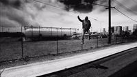 a man jumping in the air on a train track