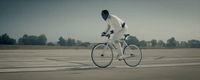 a man riding a bike down a runway