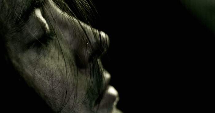 a close up of a person with their eyes closed