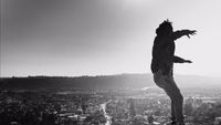 a man riding a skateboard on top of a tall building