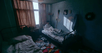 a person sitting on a bed in a room