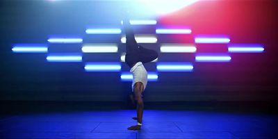 a person doing a handstand on a stage