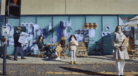 a group of people standing on the side of a road