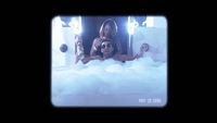 a group of people in a bathtub with bubbles