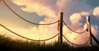 a fence with a sky in the background