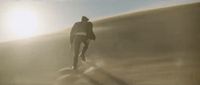 a man is walking on a foggy beach