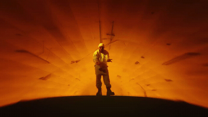 a man standing on top of a hill under a red sky