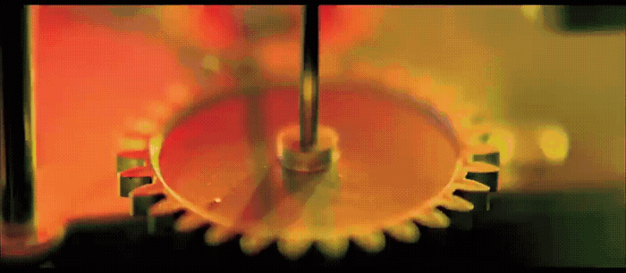 a close up of a metal gear on a table