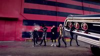 a group of people standing next to a car