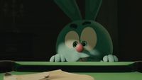 a cartoon rabbit sitting at a table with a piece of paper