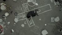 a man laying on the ground in front of a basketball court