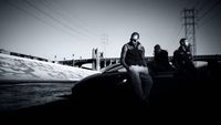 a man sitting on the hood of a car