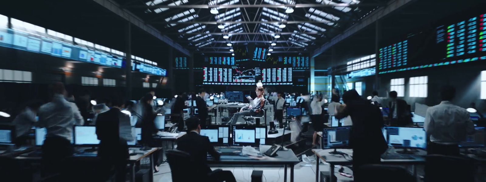 a group of people standing around a room filled with computers