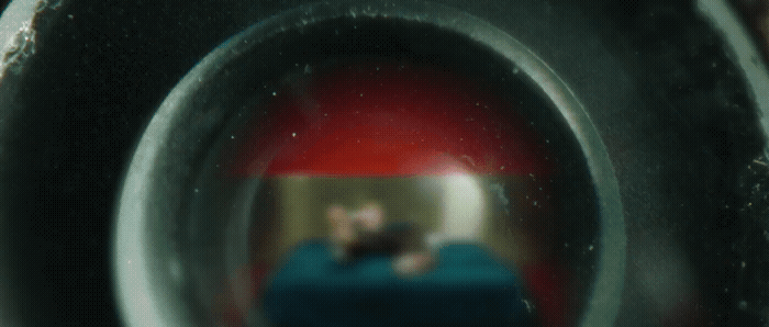 a reflection of a man in a toilet bowl