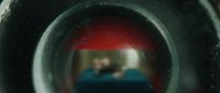 a reflection of a man in a toilet bowl