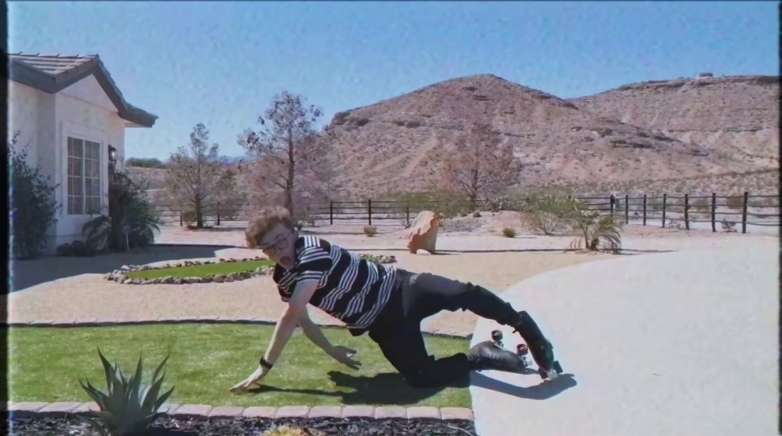 a person on a skateboard in a yard