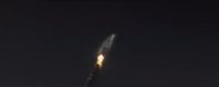 a rocket is flying through the dark sky