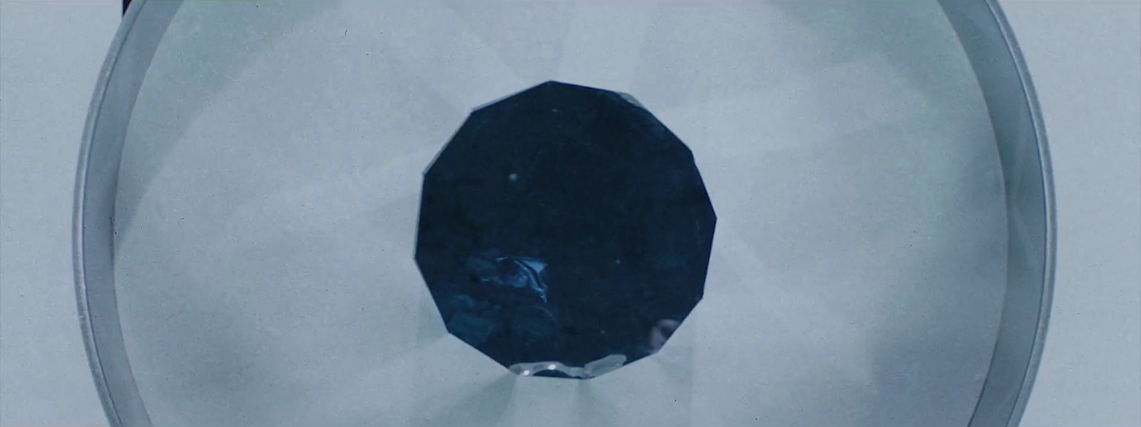 a blue diamond sitting on top of a toilet