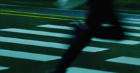 a blurry image of a person walking across a street