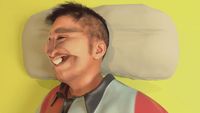 a digital painting of a man smiling with a pillow behind him