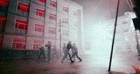 a group of people walking down a street next to a tall building