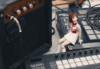 a doll sitting on top of a sound board