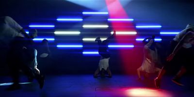 a group of people dancing in a dark room