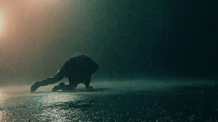 a person on a skateboard in the rain