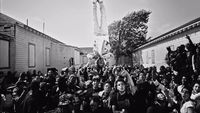 a crowd of people standing around a statue