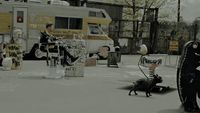 a woman walking a dog on a leash in a parking lot