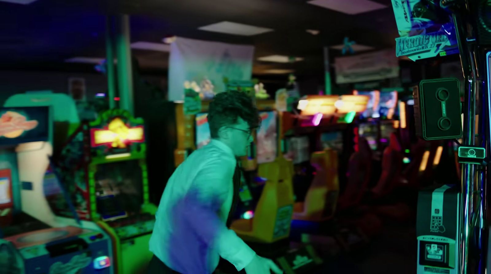 a man standing in front of a video game machine