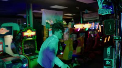 a man standing in front of a video game machine