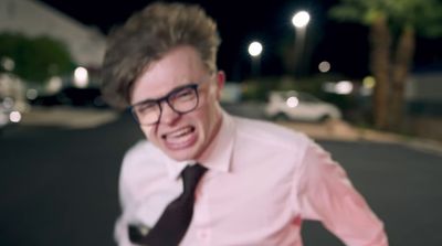 a man in a pink shirt and black tie