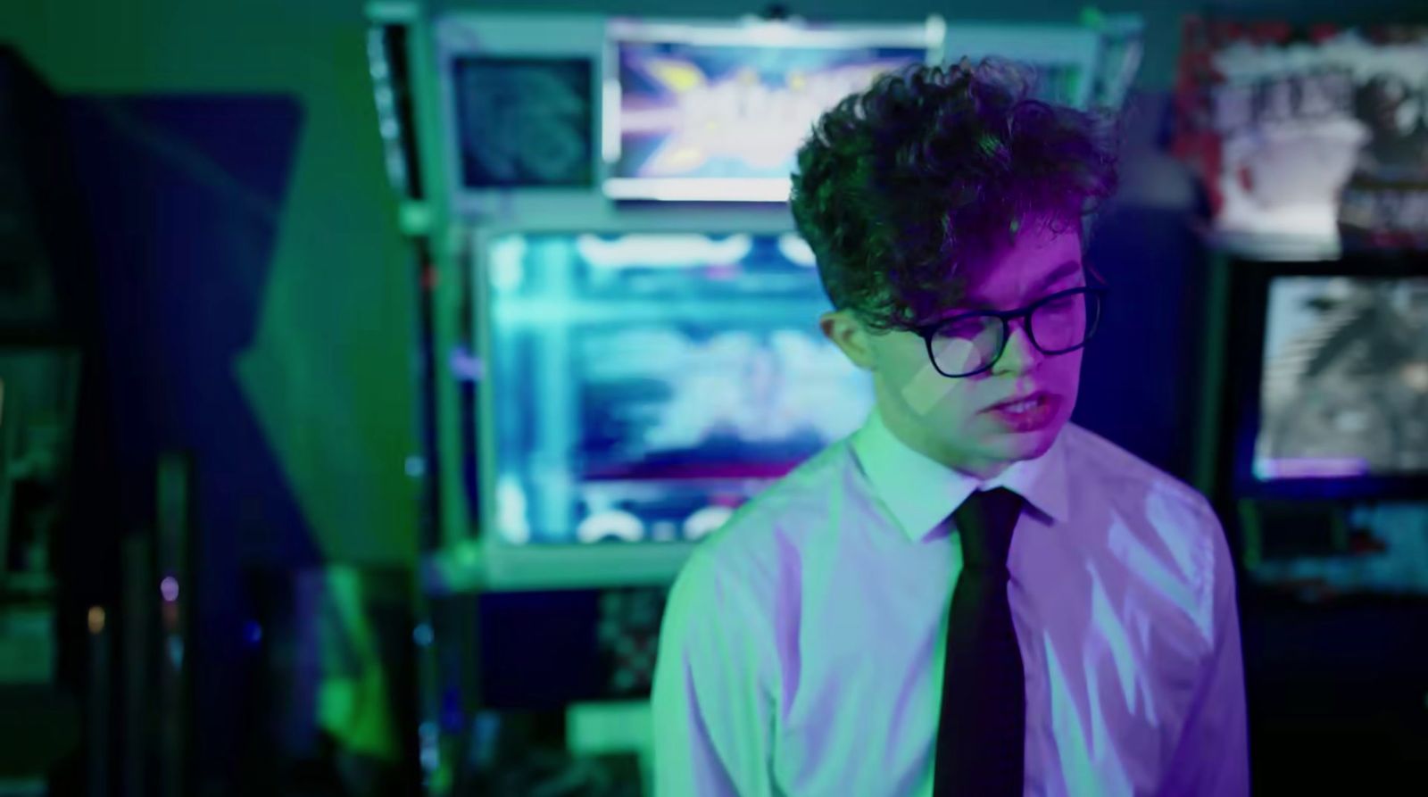 a young man wearing glasses and a tie