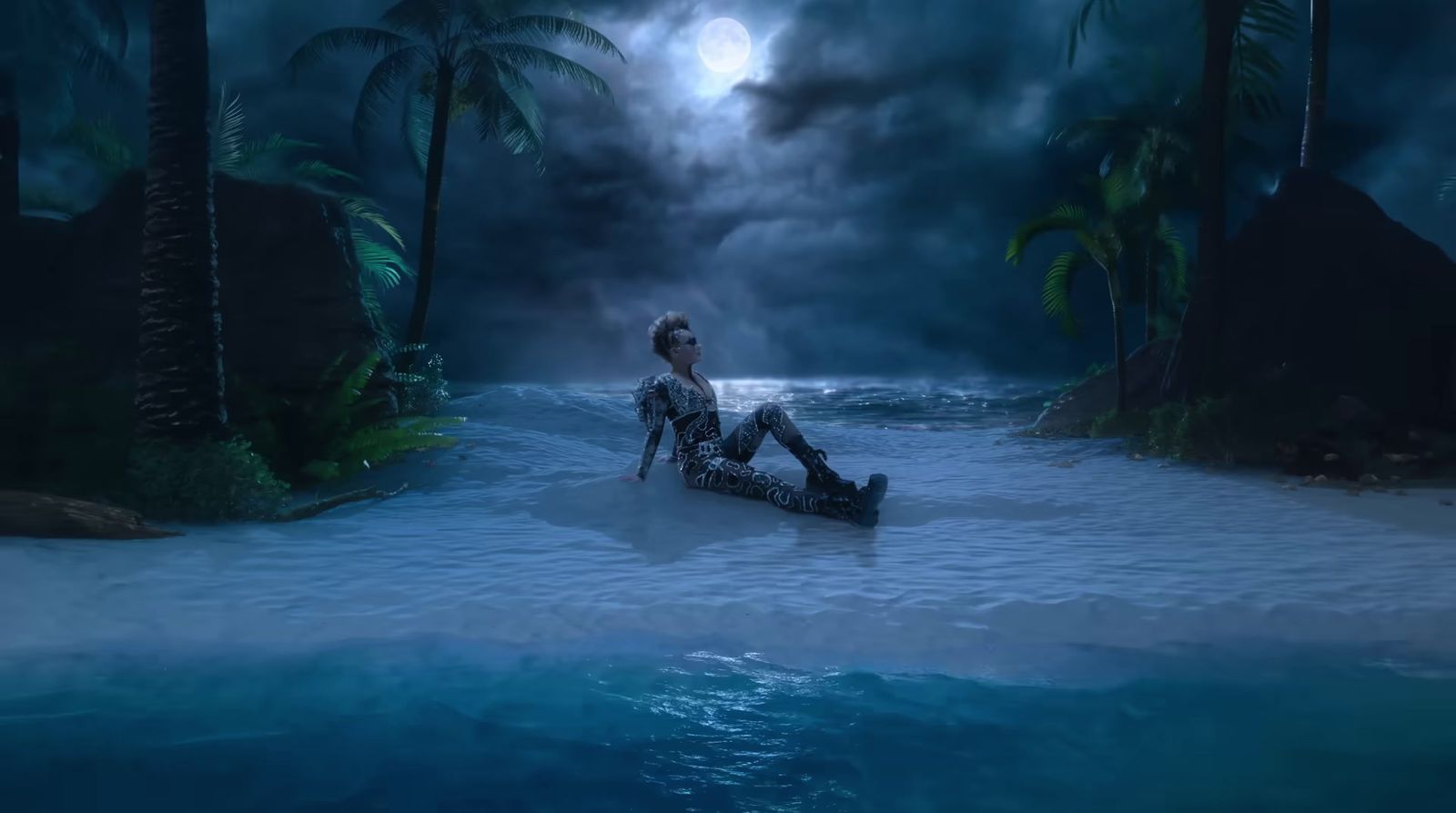 a woman sitting in the middle of a body of water