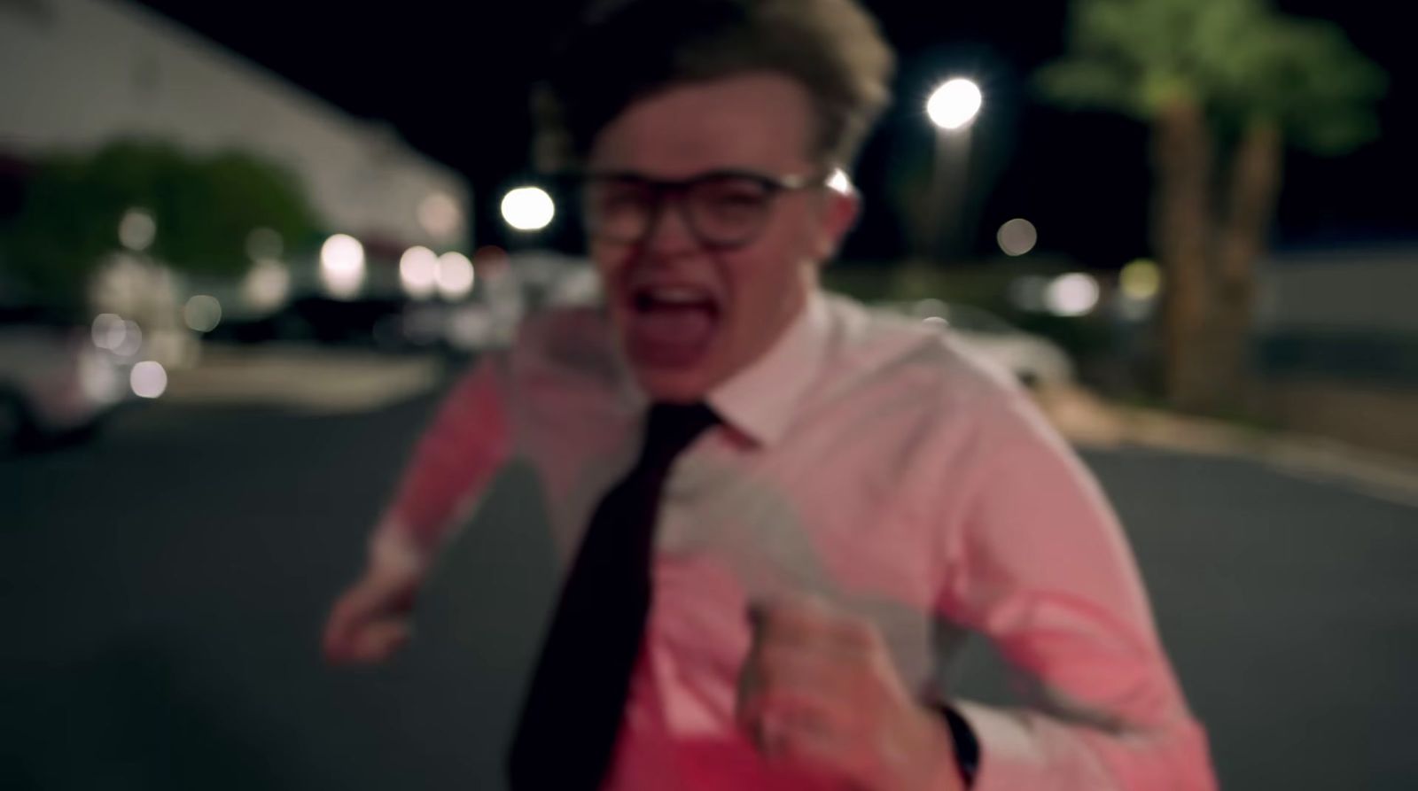 a man in a pink shirt and black tie