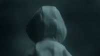 a blurry image of a woman's back