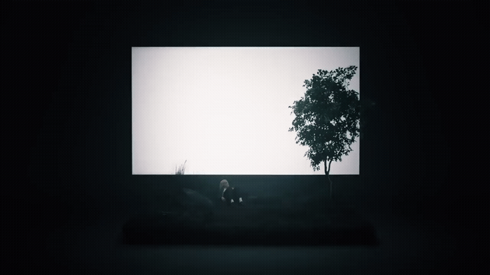 a black and white photo of a tree in a dark room