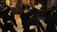 a group of young people dressed in black dancing