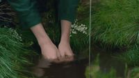 a person's feet in a puddle of water