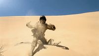 a man is running in the sand in the desert