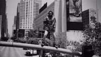 a man riding a skateboard down the side of a metal rail