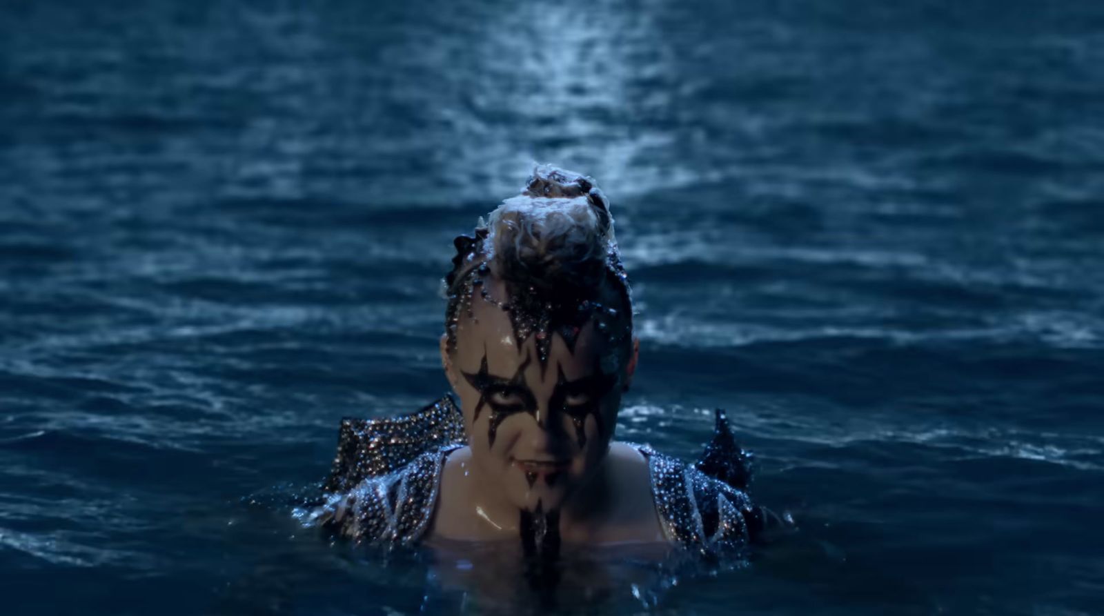 a woman in a body of water with her head in the water