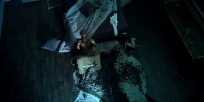 a man laying on a bed in a dark room