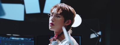 a young man wearing glasses and a red tie