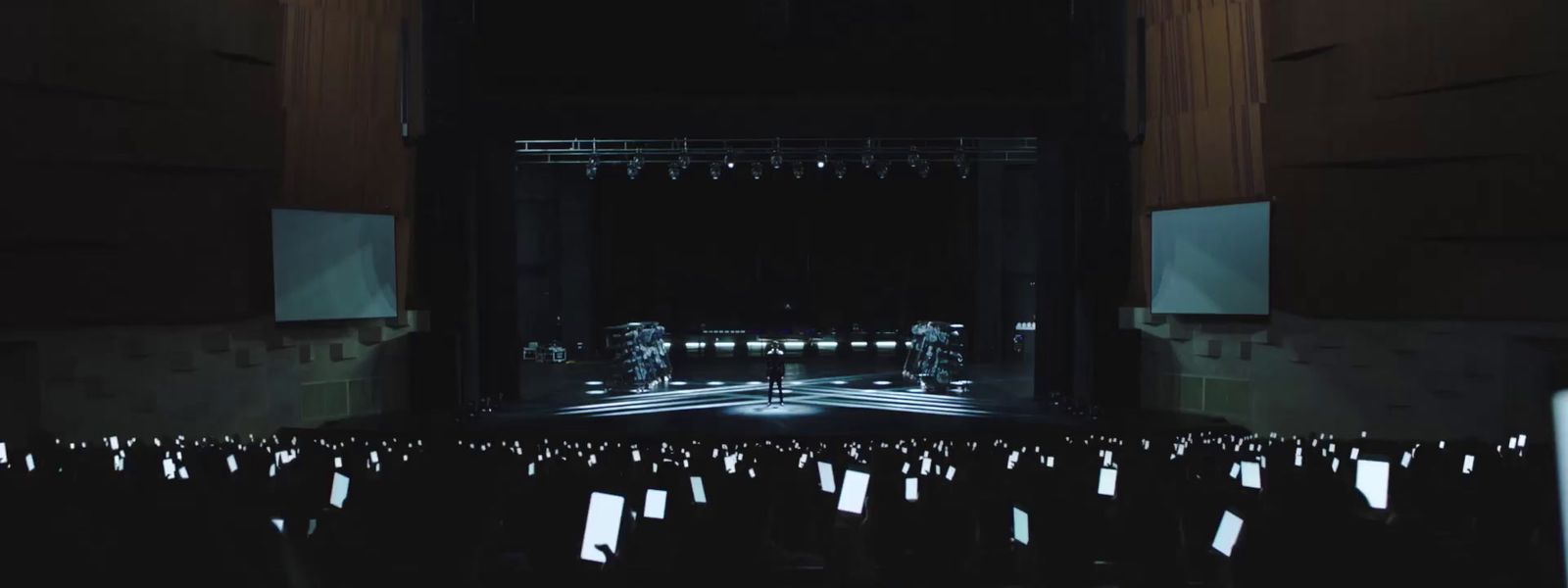 an empty stage with chairs and lights in the dark