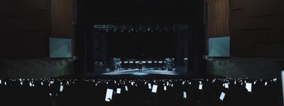 an empty stage with chairs and lights in the dark